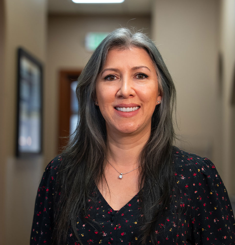 headshot of patient smiling brightly after their dental treatment