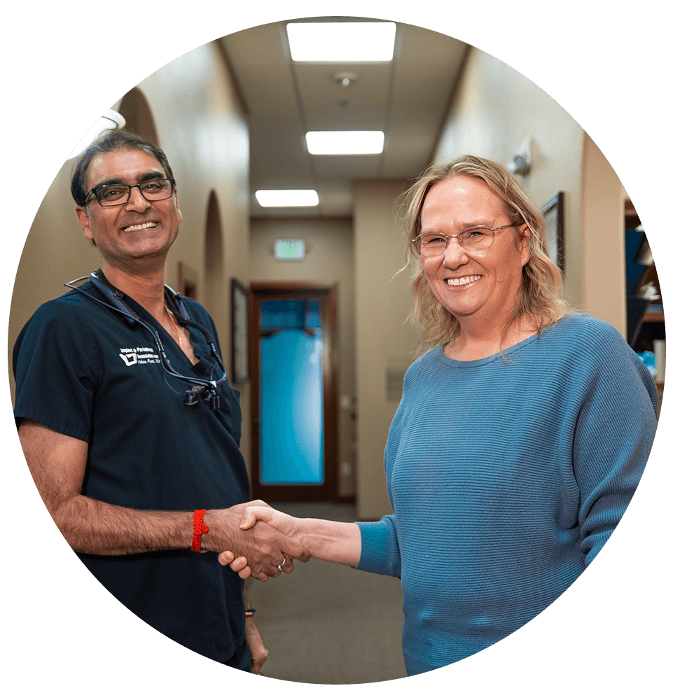 doctor and patient shaking hands after dental treatment