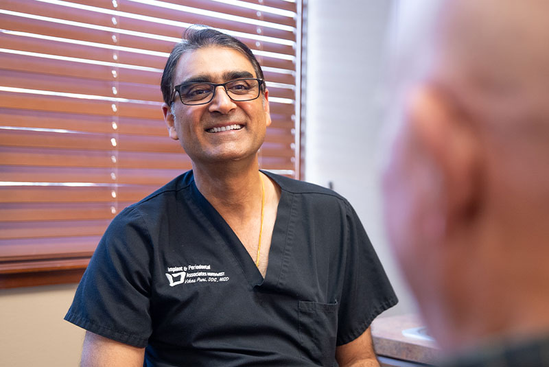 Smiling dental professional with tools