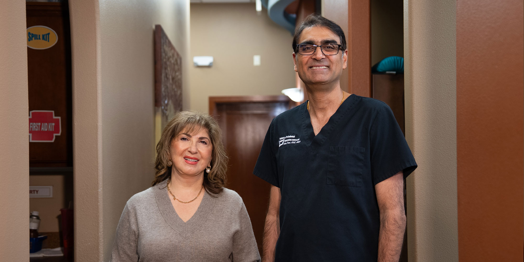 patient and doctor smiling brightly together after dental procedure