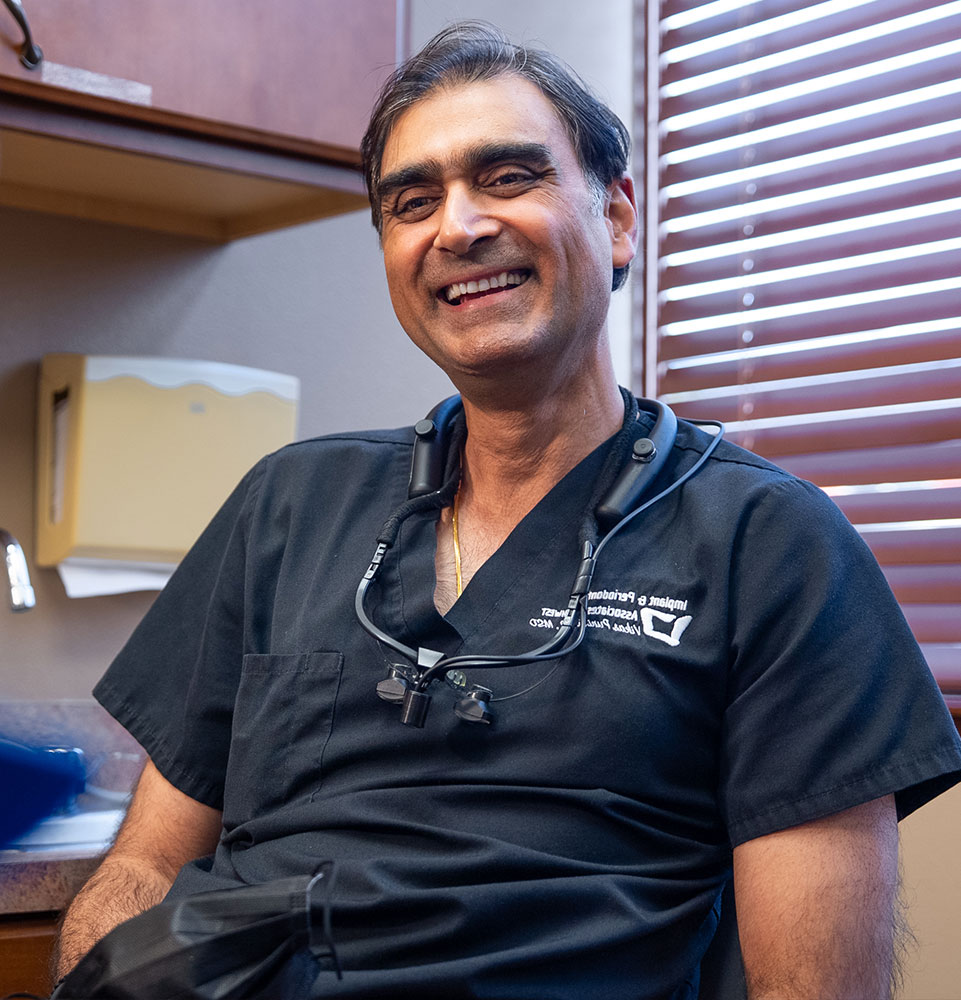 Smiling Dentist holding tools