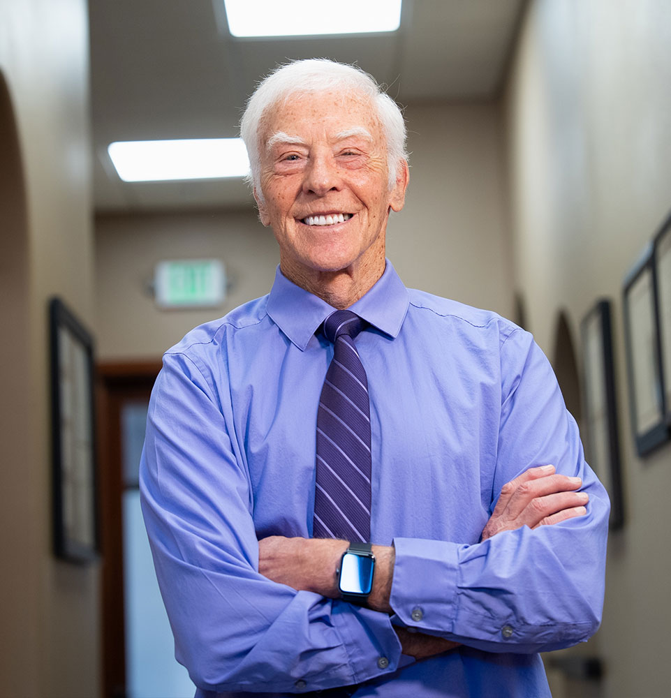 headshot of patient smiling brightly after their dental treatment