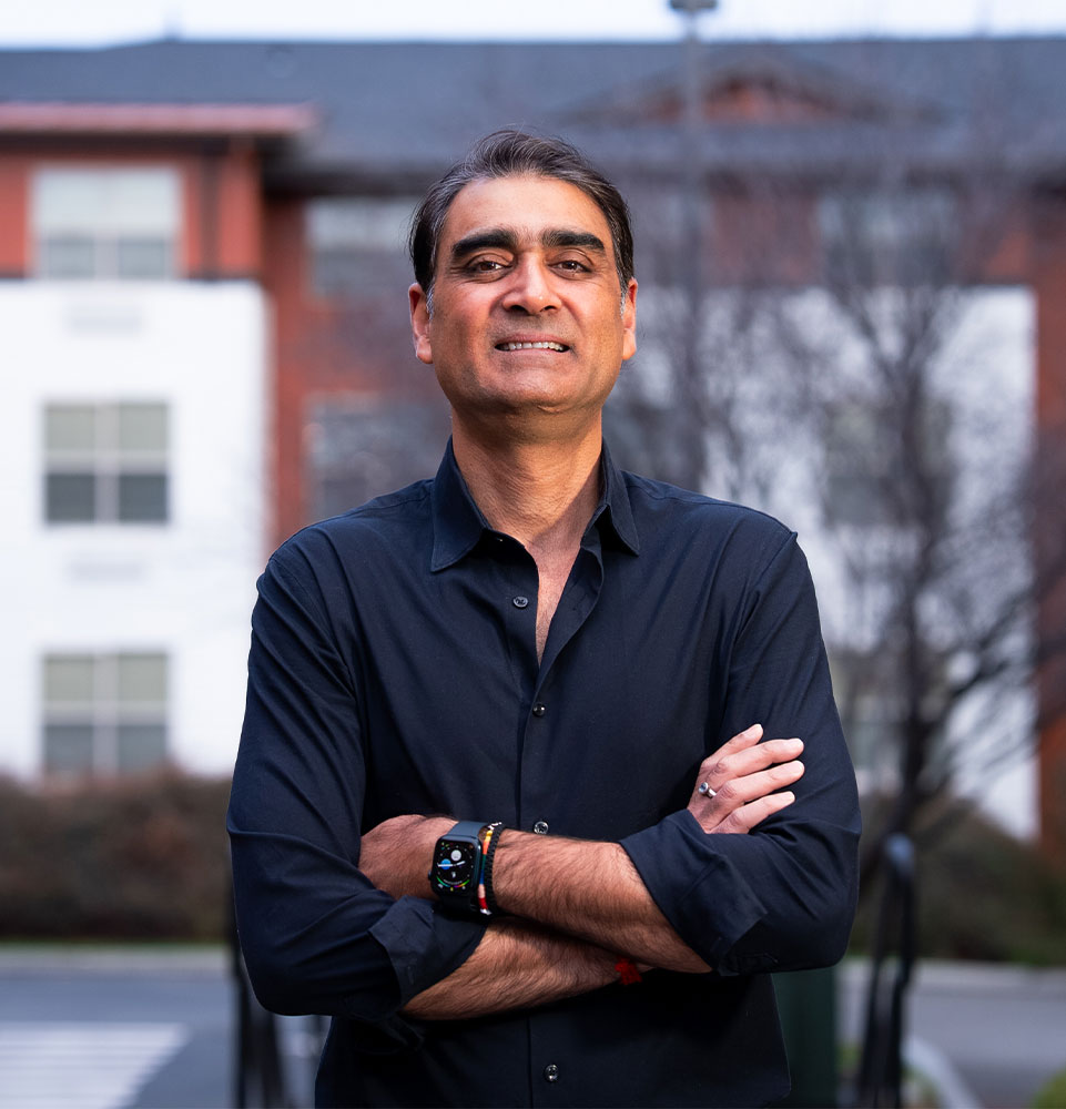 headshot of doctor smiling outside of the dental center