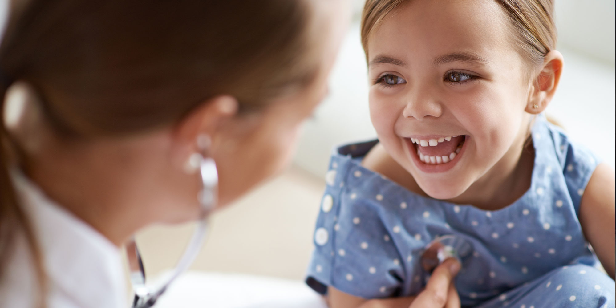 child smiling brightly at their mother
