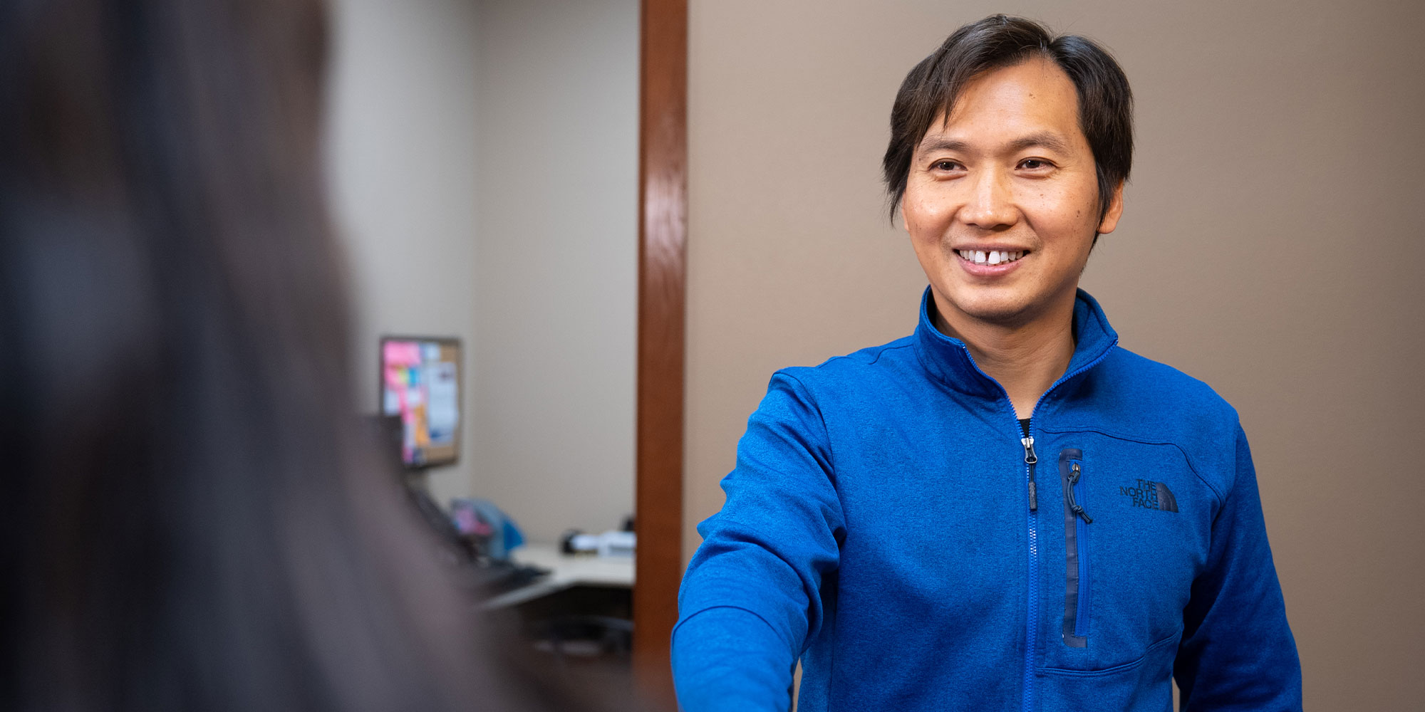 patient being helped at the front desk of the dental center