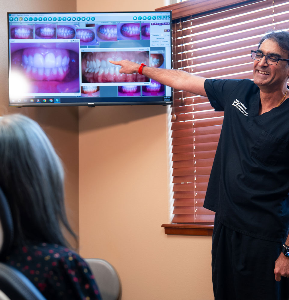 doctor showing patient dental treatment information