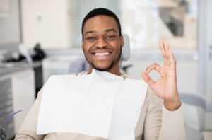 Dentist and patient discussing toothbrush options in a dental office.